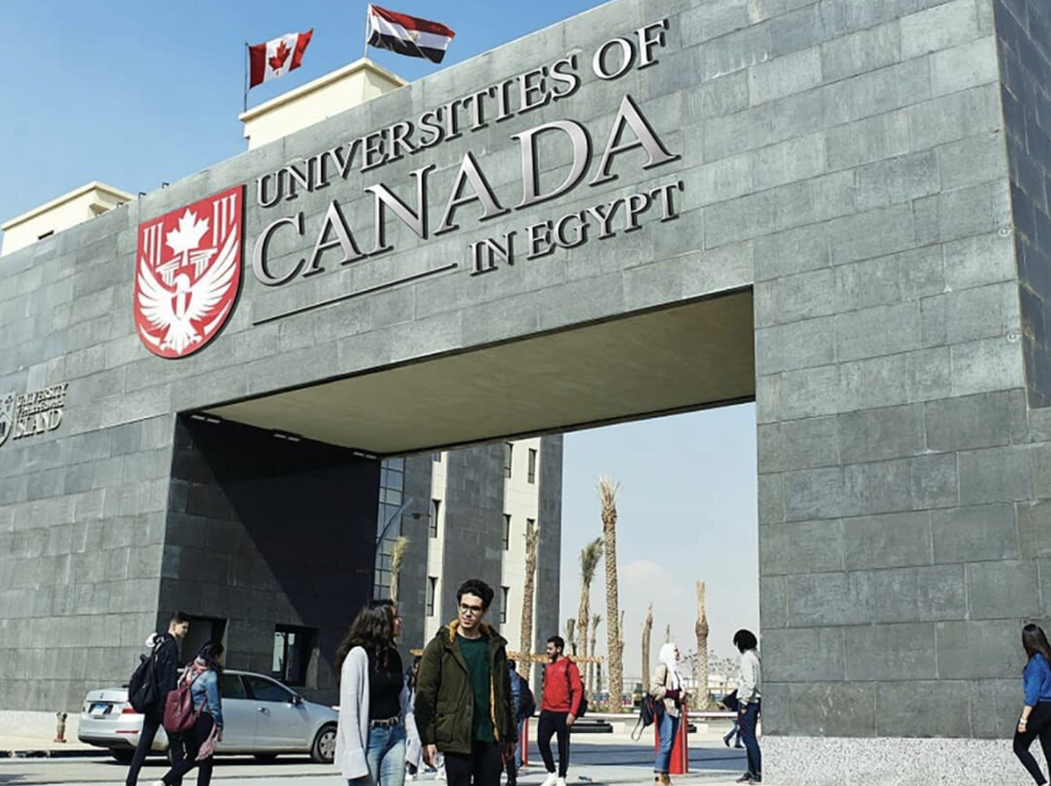 Universities of Canada in Egypt gates with students walking outside.
