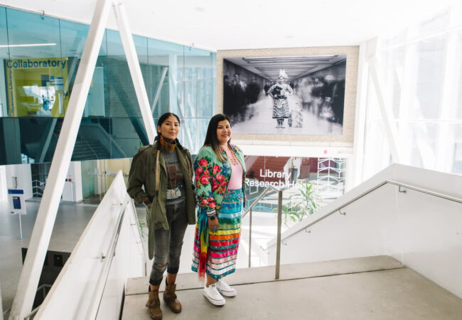 Artist Nadya Kwandibens (left) with Tee Lyn Duke standing in front of a mural.