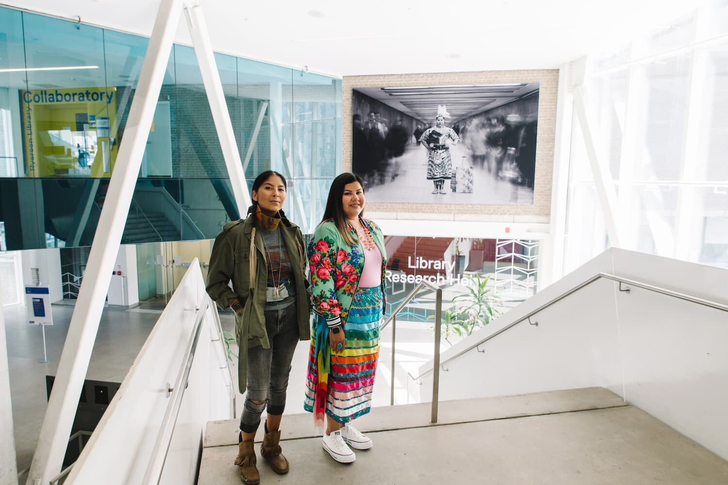 Artist Nadya Kwandibens (left) with Tee Lyn Duke standing in front of a mural.