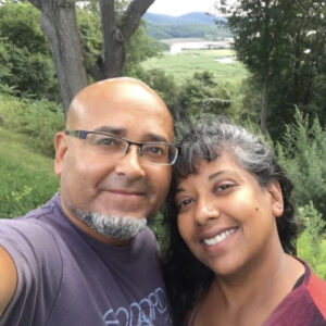 Sita Singh-Rodriguez and her husband, Pedro, taking a selfie outside.