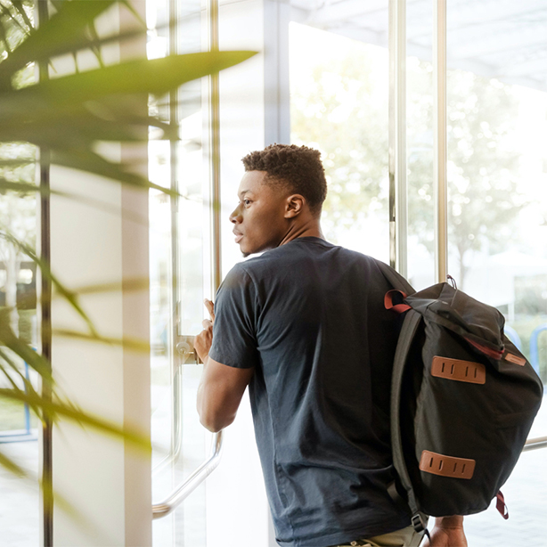 A student walking through a doorway.