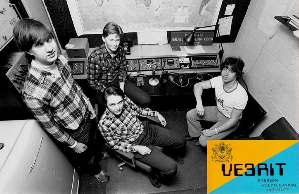 Four men in a radio recording booth.