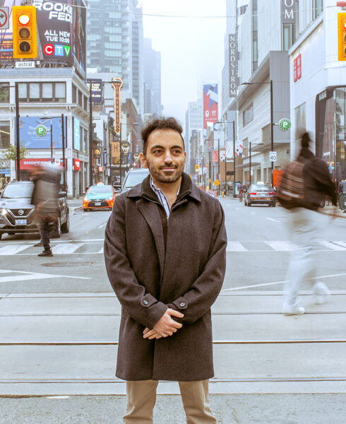Nima Feizi standing outside at Yonge and Dundas square in Toronto.