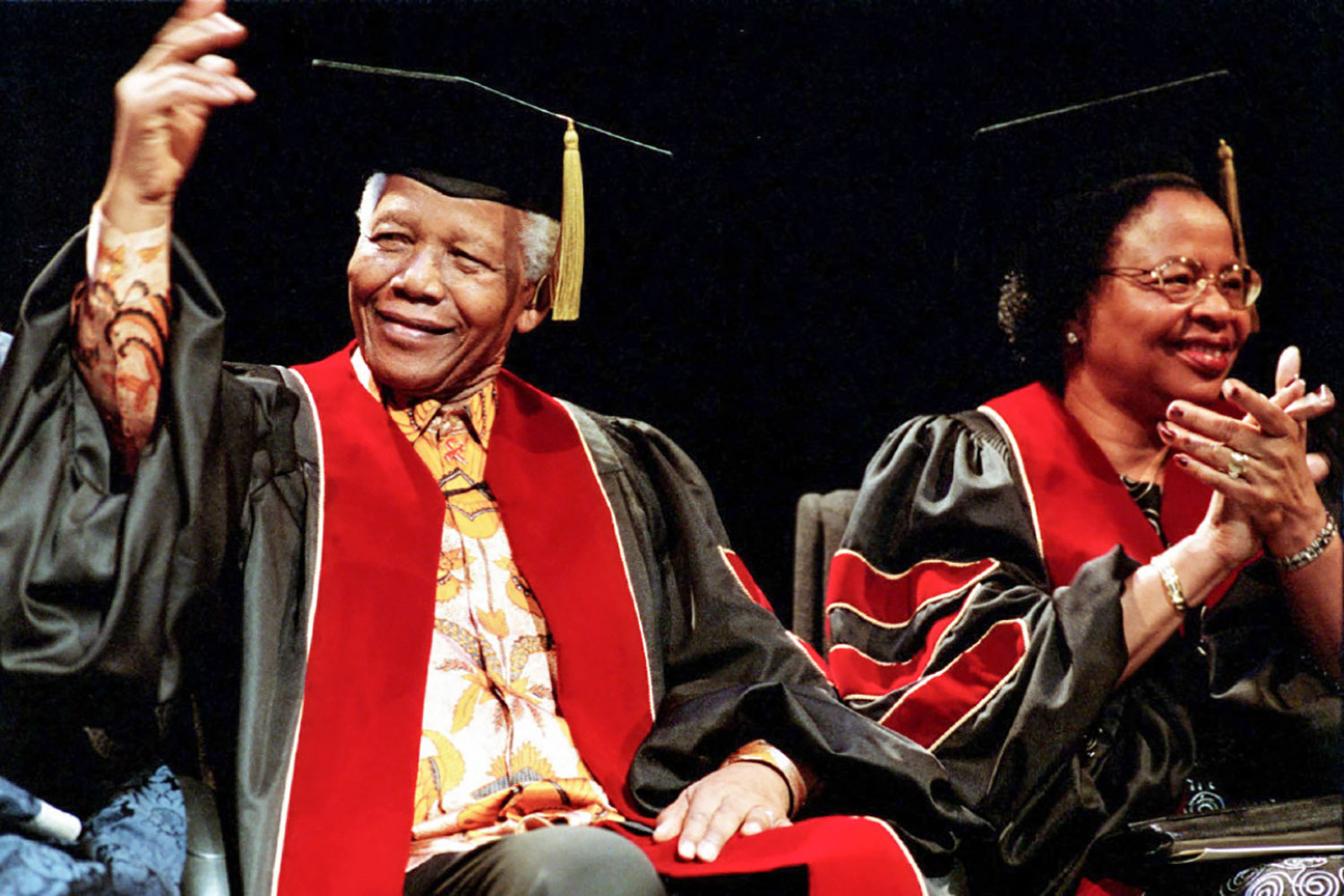 Nelson and Winnie Mandela in black and red stoles.