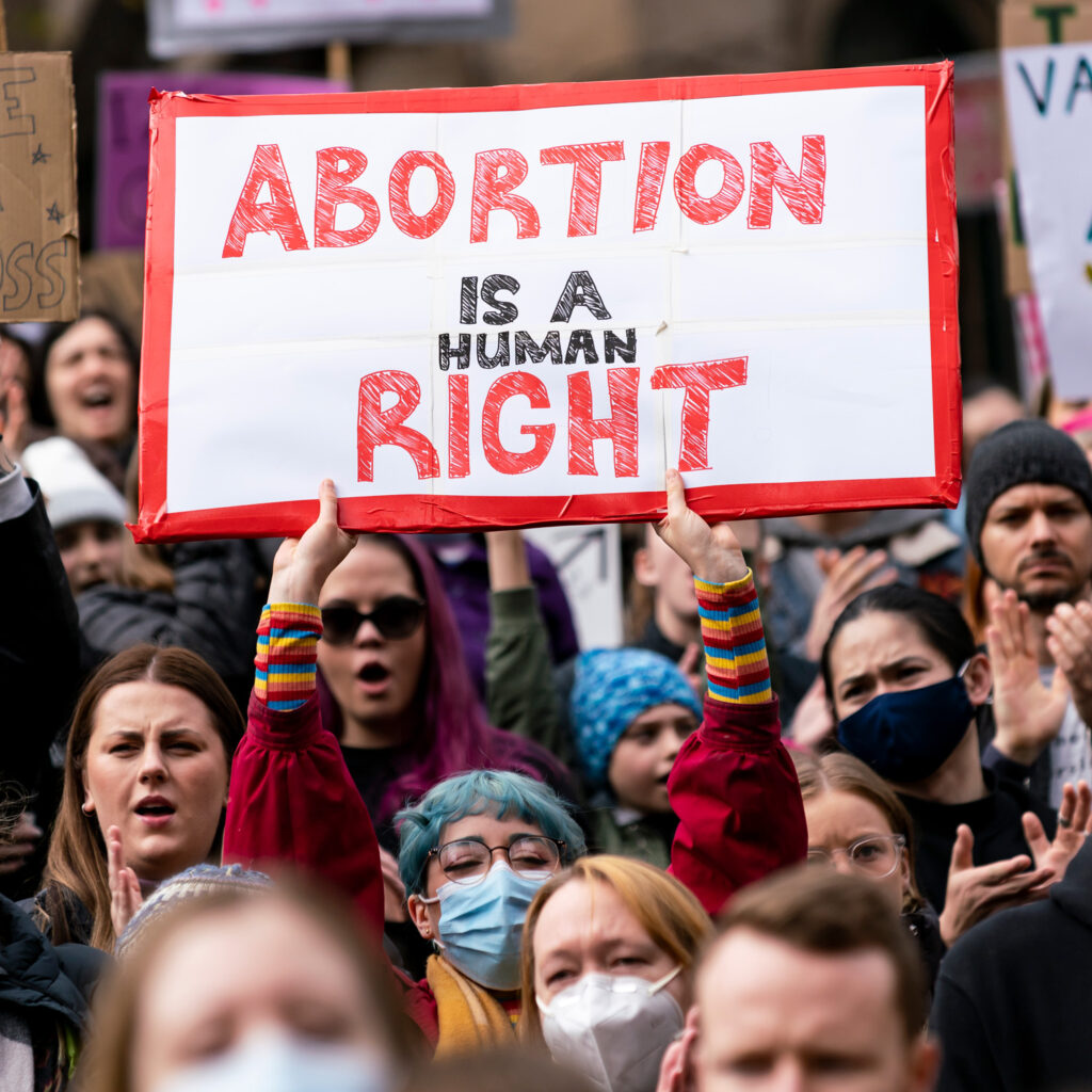 A group of protestors holding a sign saying "Abortion is a right."