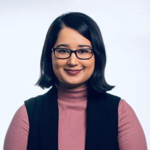 Gurneet Dhami wearing a pink turtleneck and black vest.