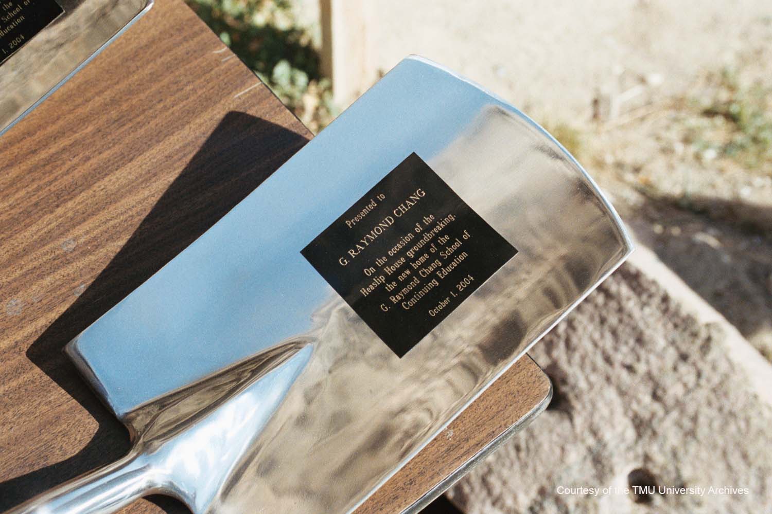 A shiny shovel with an inscription dated Oct. 1, 2004, presented to G. Raymond Chang.