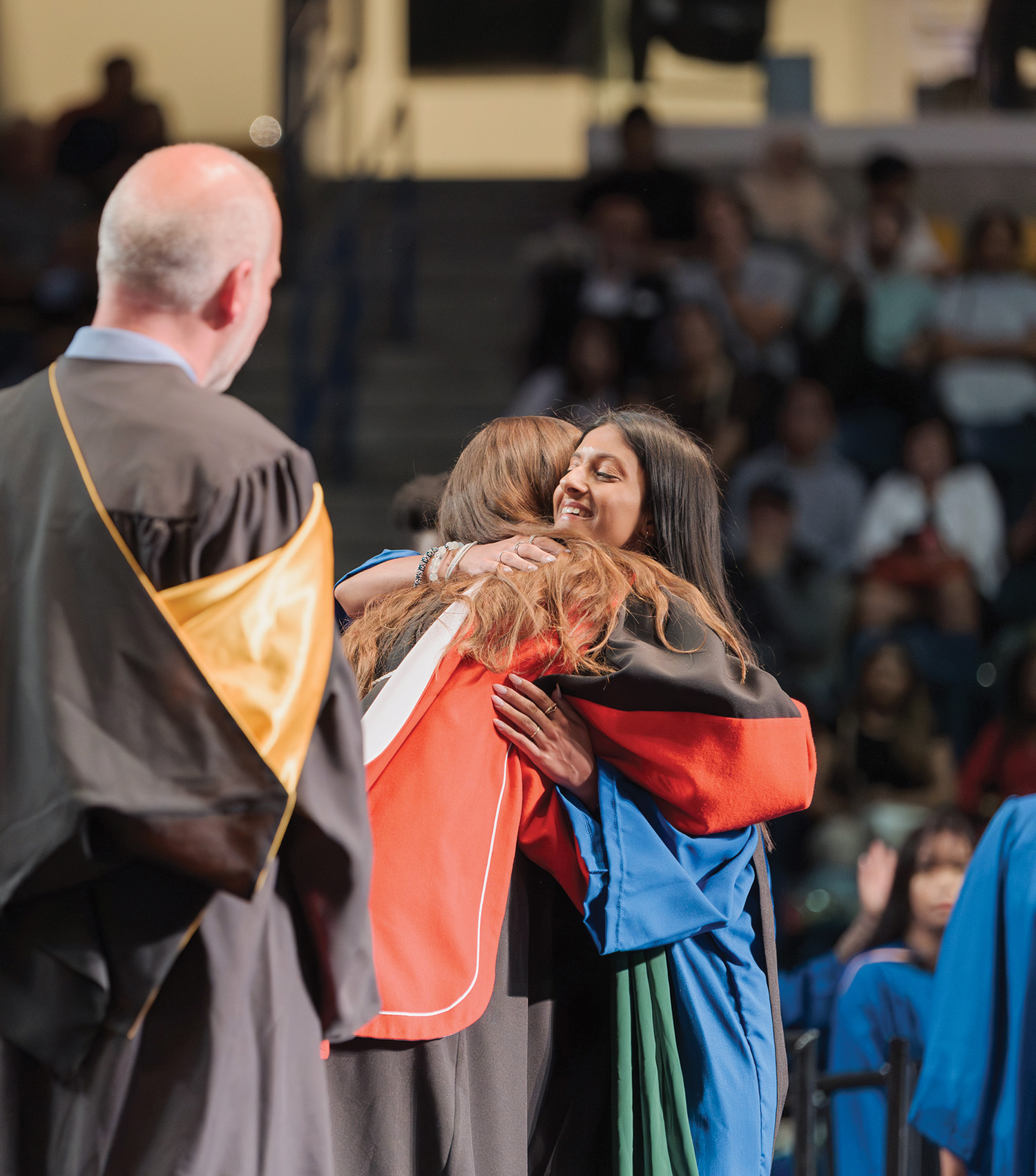 Afsana Lallani shares a hug on the convocation stage after graduating in Spring 2023.