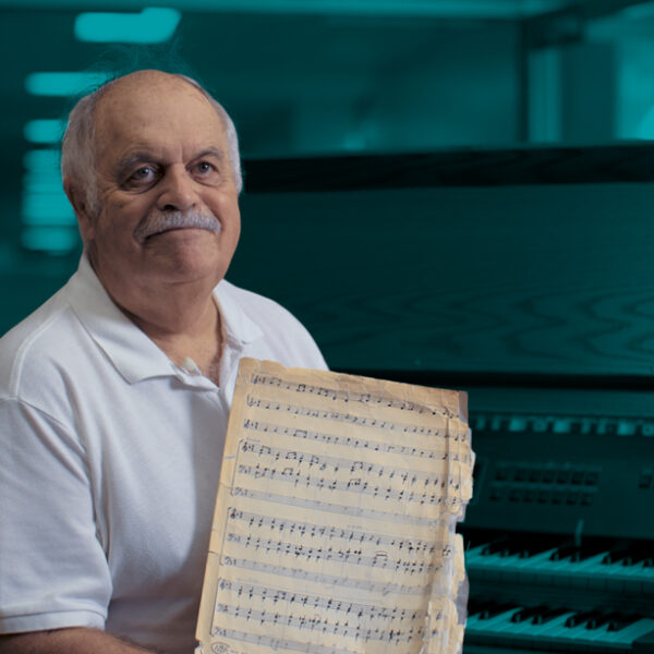Wayne Detcher holding a sheet of music.