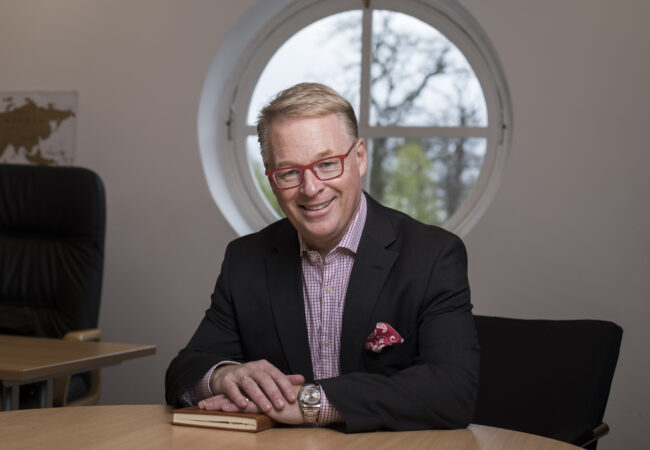 Keith Pelley sitting at a desk.