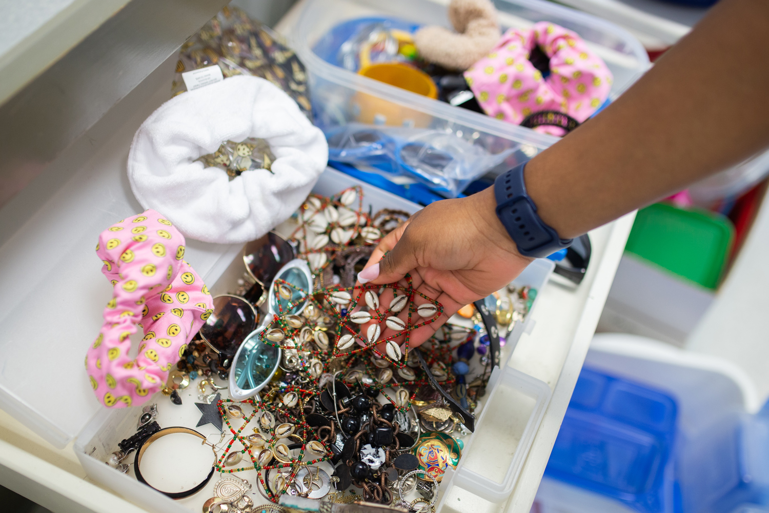 A bucket of necklaces and hair ties.