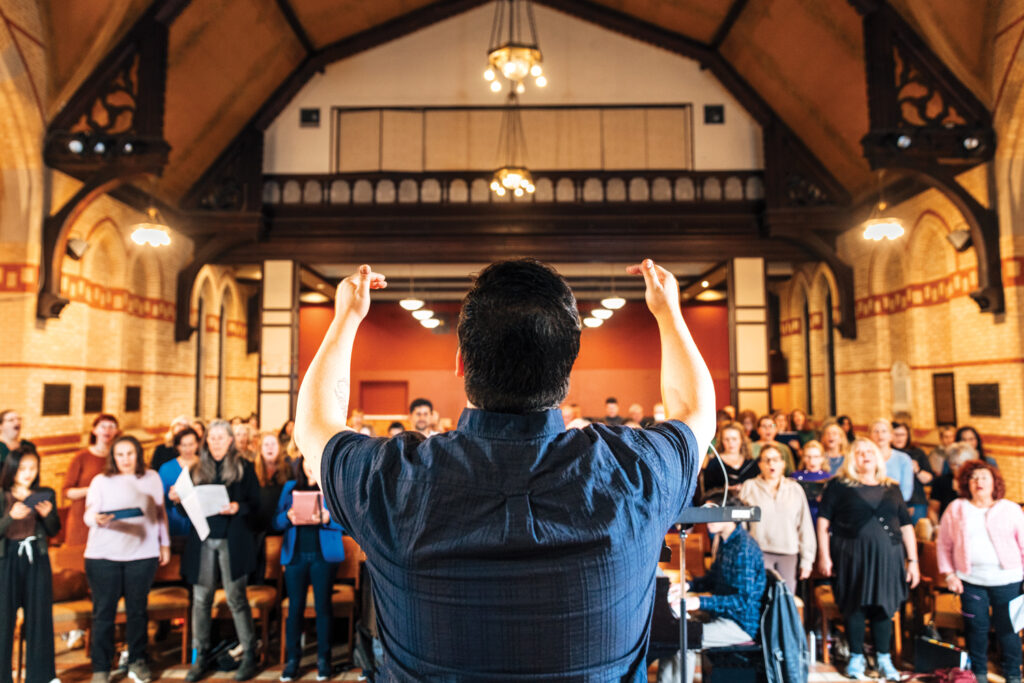 A person conducts a choir.