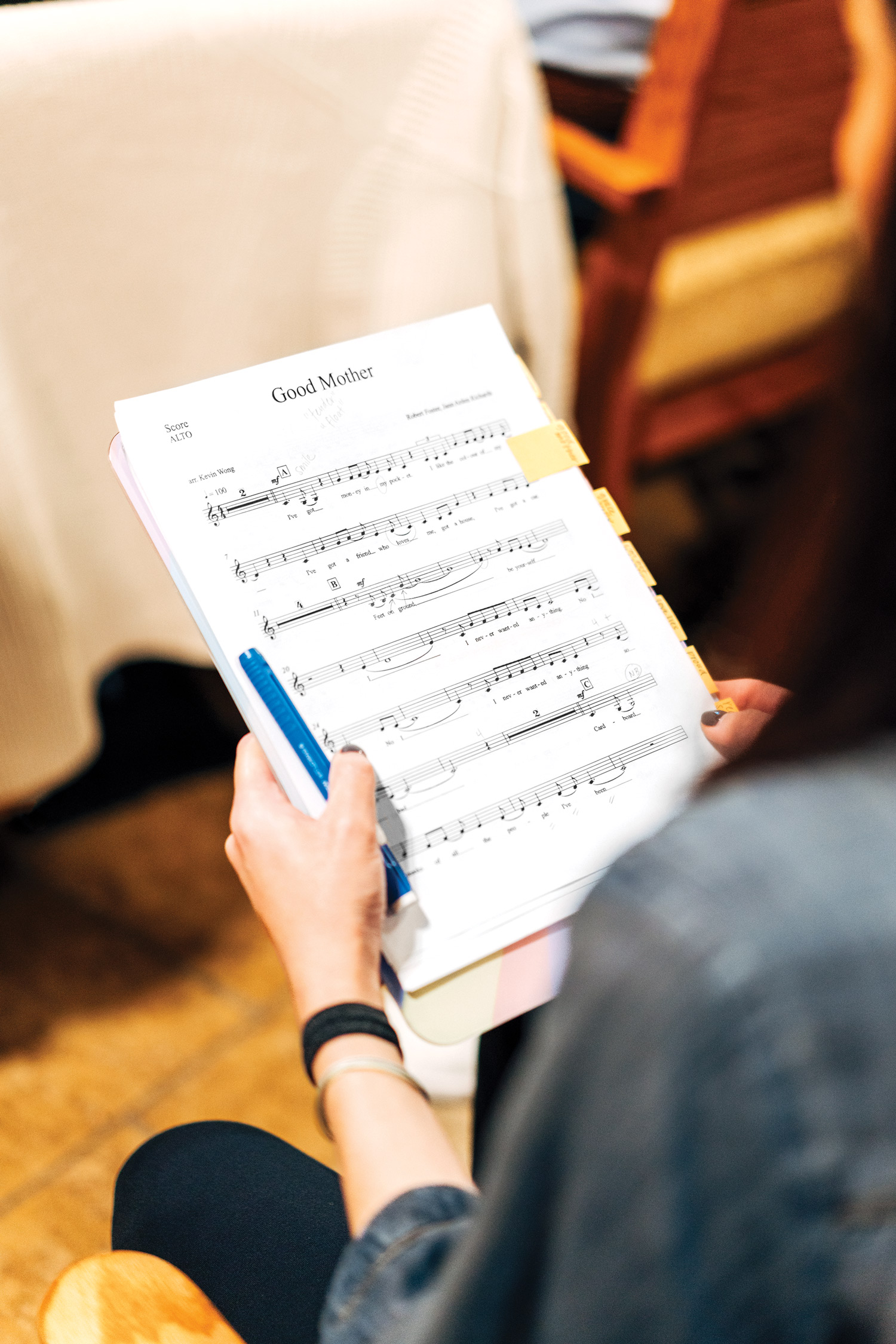 A person holding sheet music.