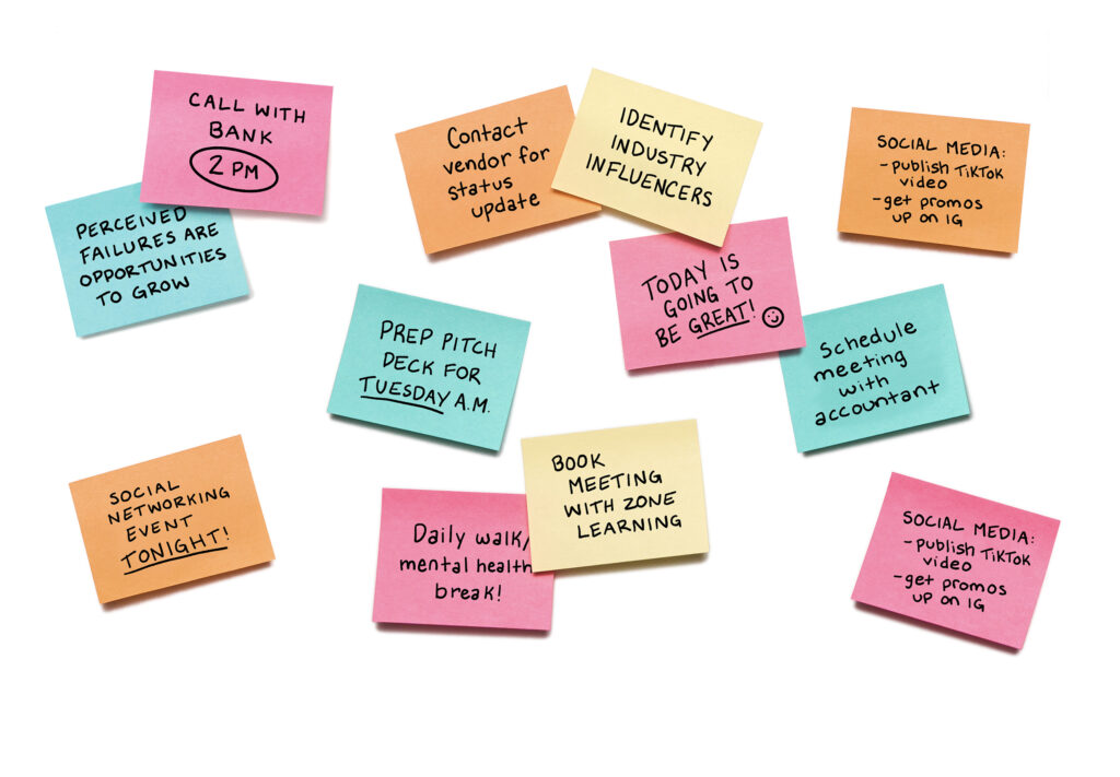 A bunch of post-it notes with various reminders written on them.