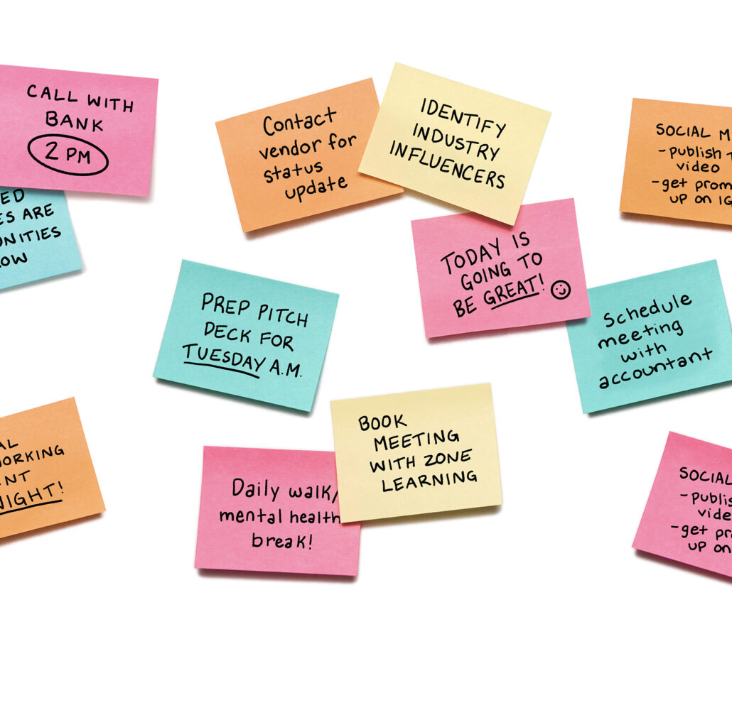 A bunch of post-it notes with various reminders written on them.