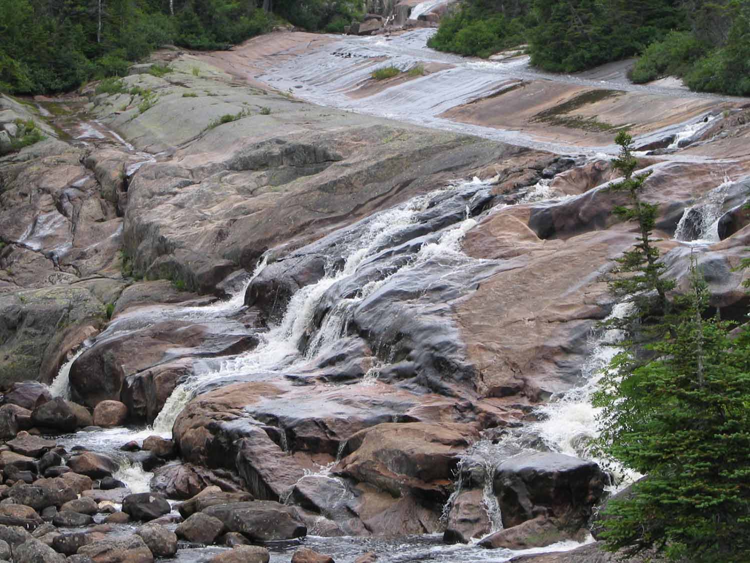 River streaming down parts of granite rock formation that make up part of the Canadian Shield. The boulders from Lake Devo came from these formations.