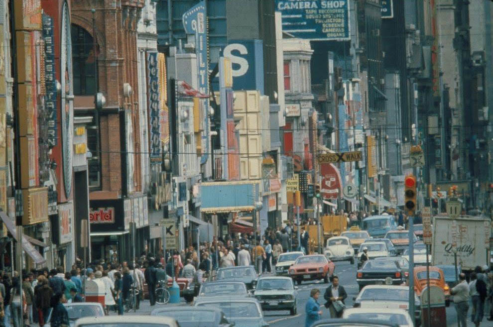 Yonge street in the 70’s or 80’s showing busy car and pedestrian traffic.
