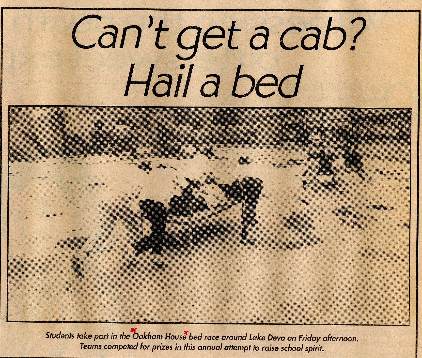 Newspaper photo clipping of students pushing beds around an empty Lake Devo.