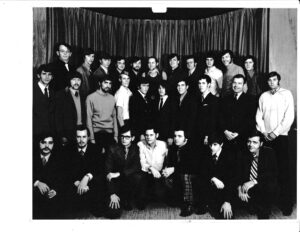 A group of people pose in three rows for a photo.