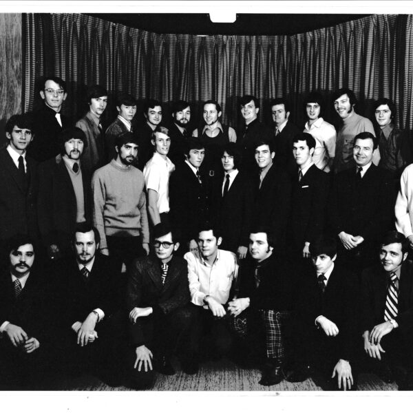 A group of people pose in three rows for a photo.